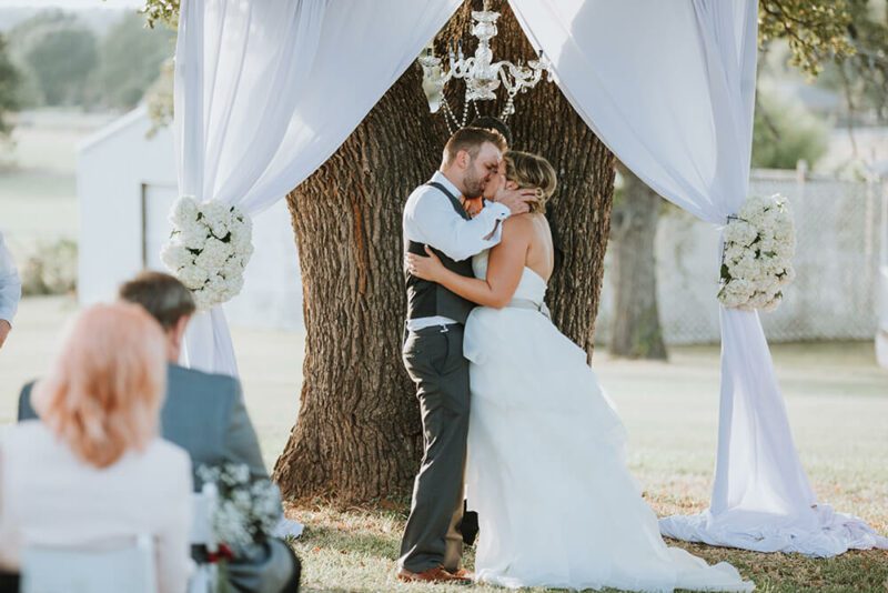 bride and groom first kiss