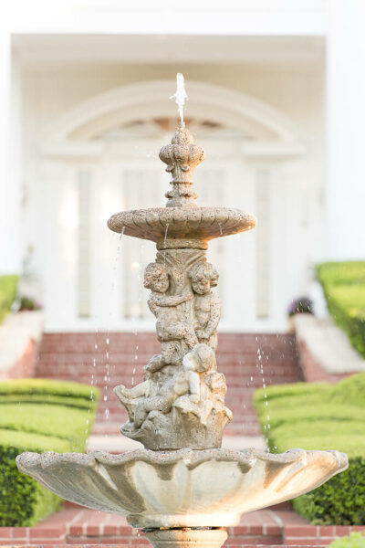 water fountain in front of mansion