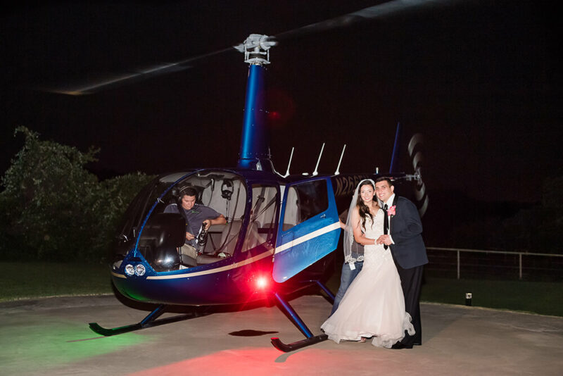 bride and groom outside a helicopter