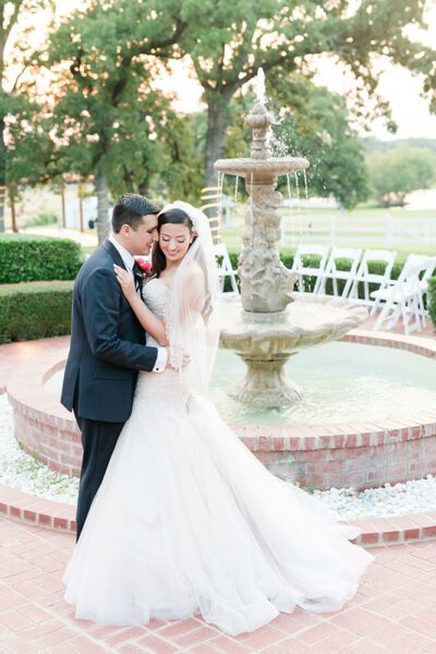bride and groom photo in front of water fountain
