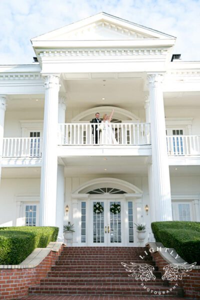 bride and groom up on balcony