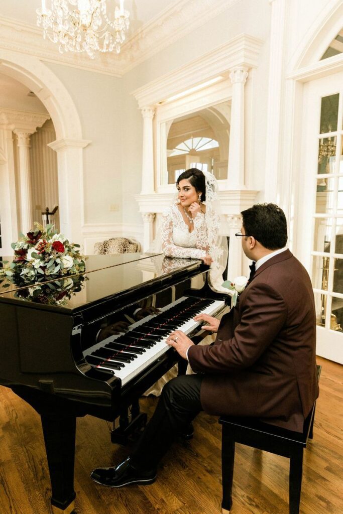 bride and groom posing with a piano
