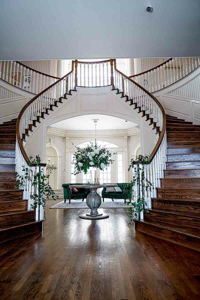 double staircase inside white mansion