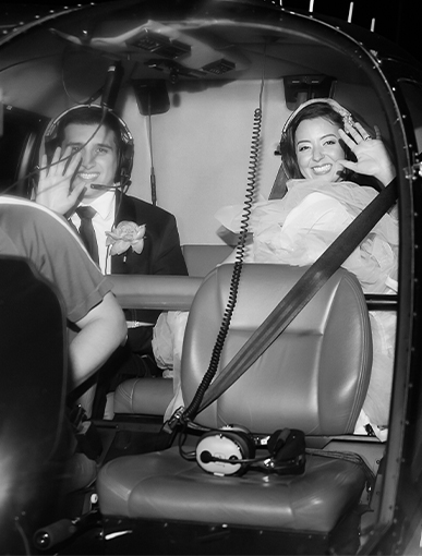 bride and groom flying off in a helicopter