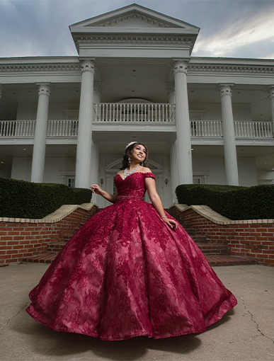 girl outside lonestar mansion in her red Quinceañera dress